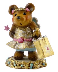 Bear dessed in party frock with wings, a  wand and large carrier bag