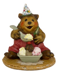 Bear sitting with party hat and a large bowl of ice-creams