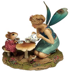 A fairy and a young girl mouse have tea at a toadstool table