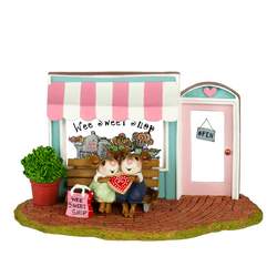 Loving couple share special cookie outside Wee Sweet Shop