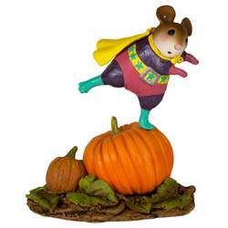 Girl superhero standing on a large pumpkin