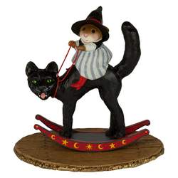 Girl witch sitting on a rocking black cat