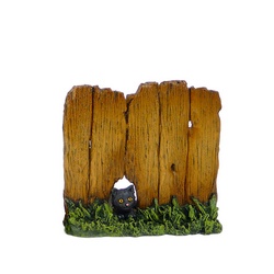 Wood fence with cat looking though hole