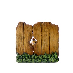 Wooden fence with mouse peeping through a hole