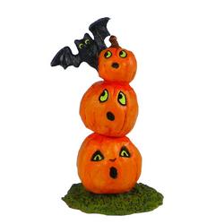 Three pumkins high with a bat on top