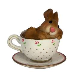 Snuggly bunny found taking a nap in a tiny tea cup.
