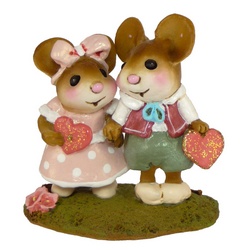 Two young mice hold hands and Valentine's hearts