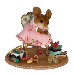 Young female mouse sitting on a chair surrounged by shoes