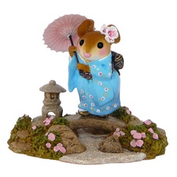 Traditionally dressed Japanese lady mouse with an umbrella in her garden