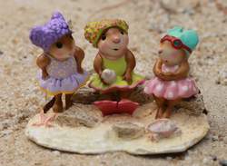 Three adorable beach mice enjoying a carefree day by the shore