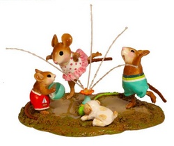 carefree mouse children splash and play in a sprinkler.