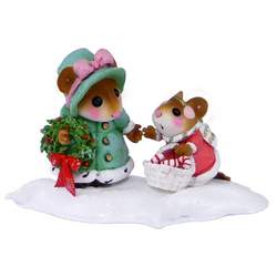 Mother mouse holding wearth and duaghter with cnady cane basket treking through the snow