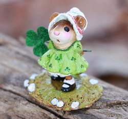 Lucky Lucy is dressed in her sweet St. Patrick's Day best. She holds a sparkly shamrock behind her back. 