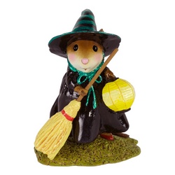 Little black witch holding yellow broom and lantern