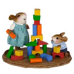 Girl mouse builds a wood block tower with little brother