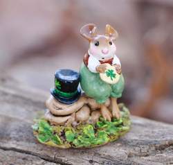 Seated on a little rock wall, this Irish mouse eats a St. Patrick's Day treat. 
