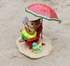 Mother mouse sitting on a beach chair with a watermelon slice and a good book.