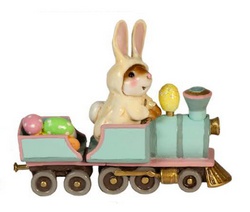 Here comes a mouse, dressed as the Easter bunny driving the Easter train, carrying pastel colored Easter eggs .