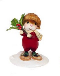 Young mouse with holly branch snow shoeing