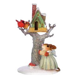 Christmas bird house in a tree with angel mouse at base