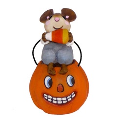small mouse sits on oversized pumpkin bucket eating a candy corn
